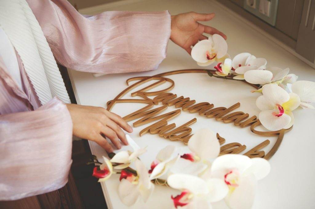 Close up Muslim woman hands with home decor text word Ramadan Mubarak
