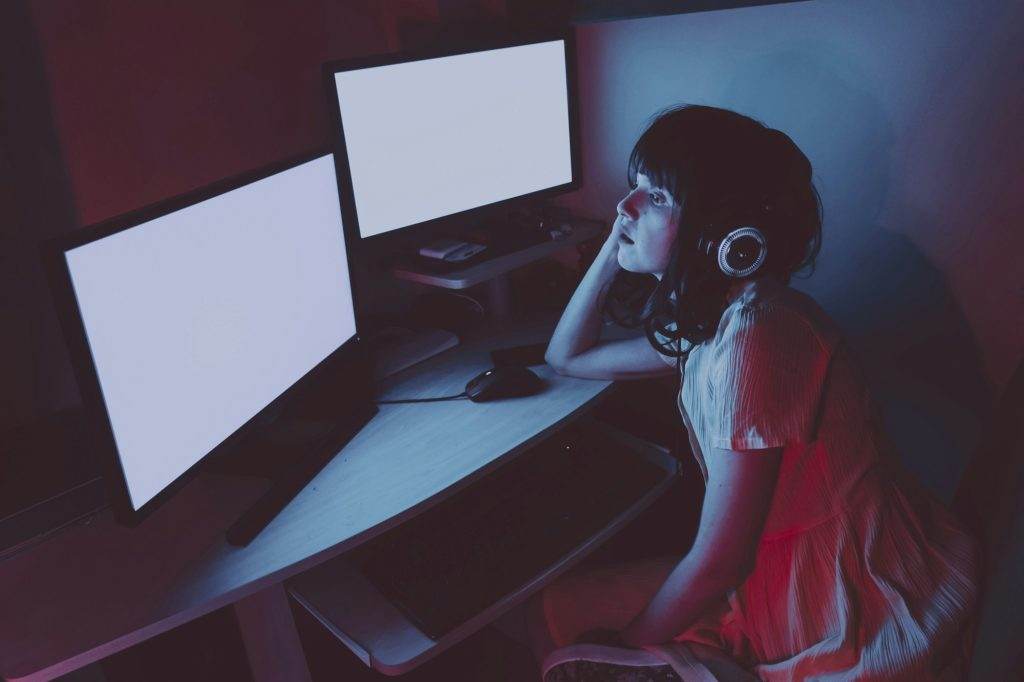 Young streamer woman working at night from home