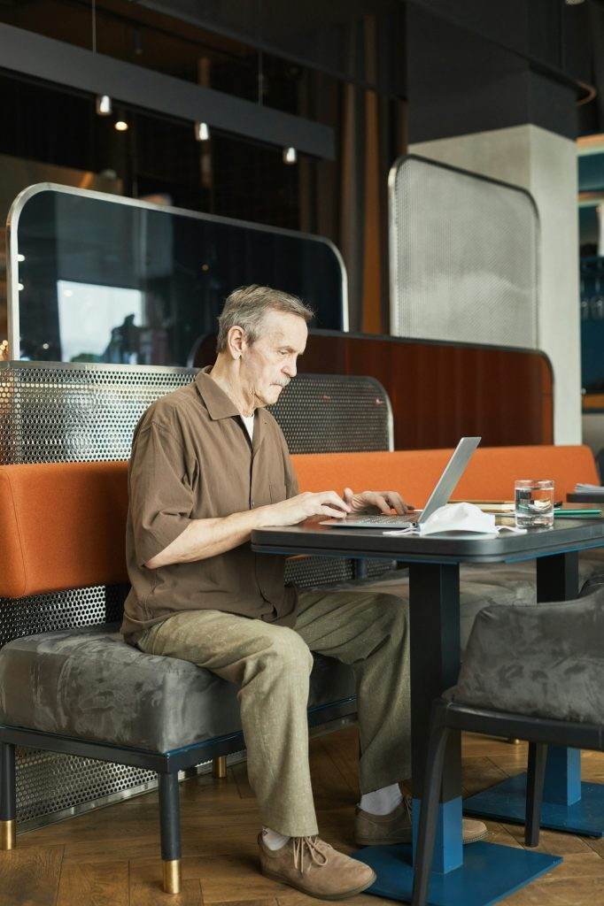 Busy mature man working with requests on website