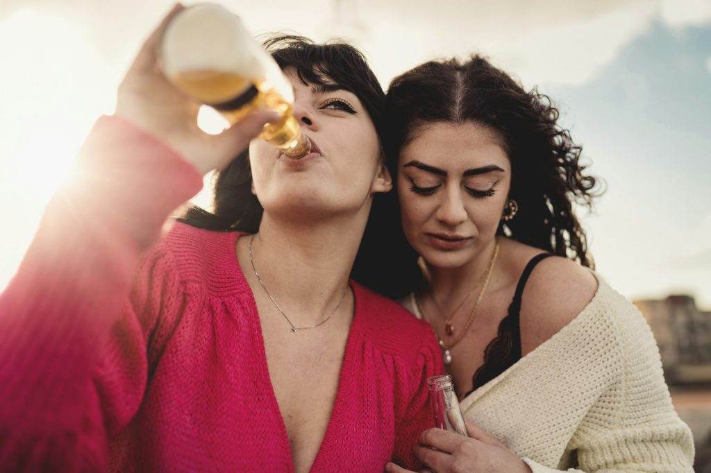 Girls drinking beers outdoors