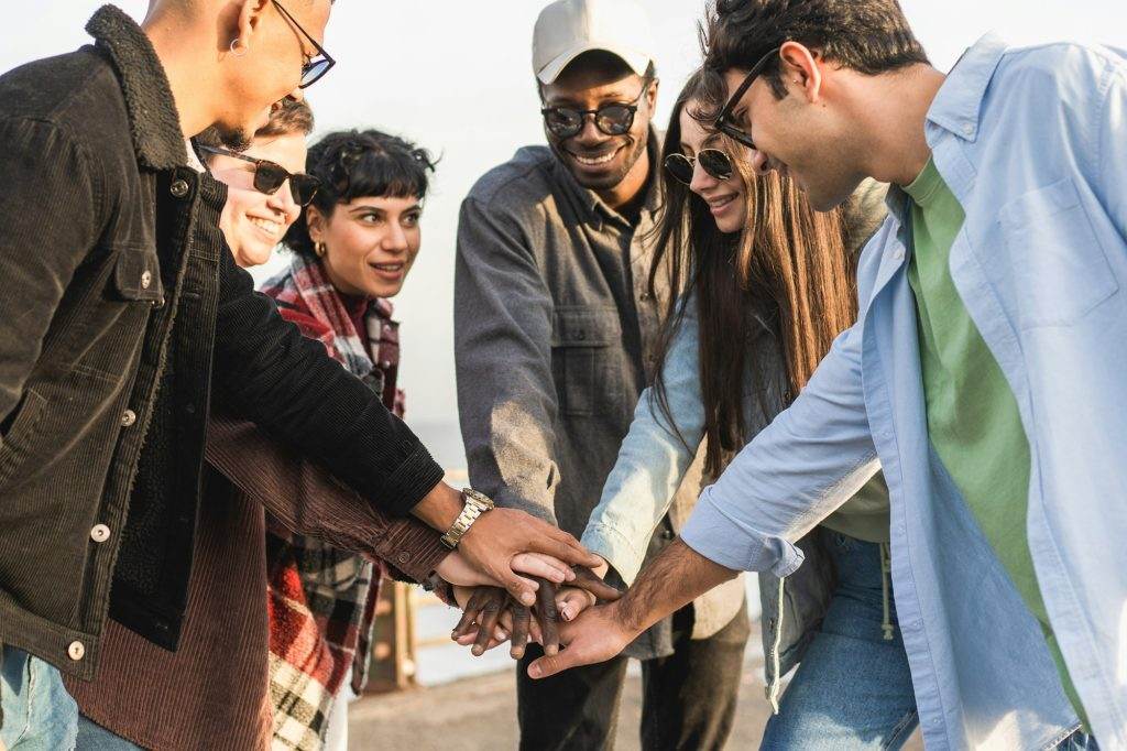 Multiracial Friends United Hands by the Seaside