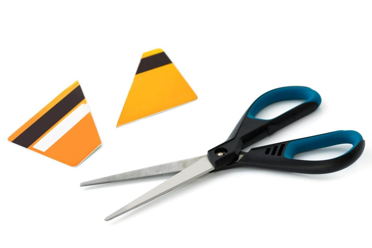 Scissors and cut credit card on white