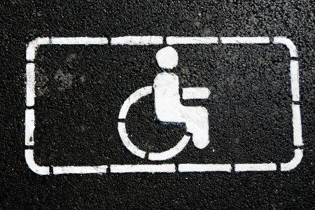 Handicap symbol on road. Road marking on the asphalt with parking spaces for the disabled.