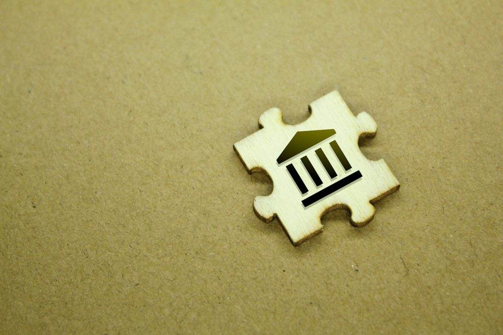 wooden puzzle with icon or bank shape.