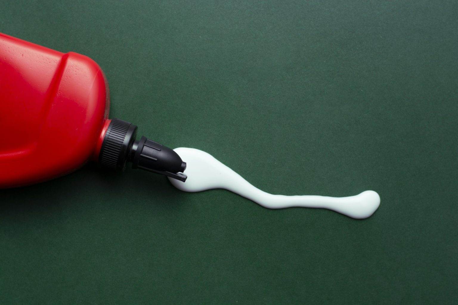 Closeup shot of spilled glue with a red container