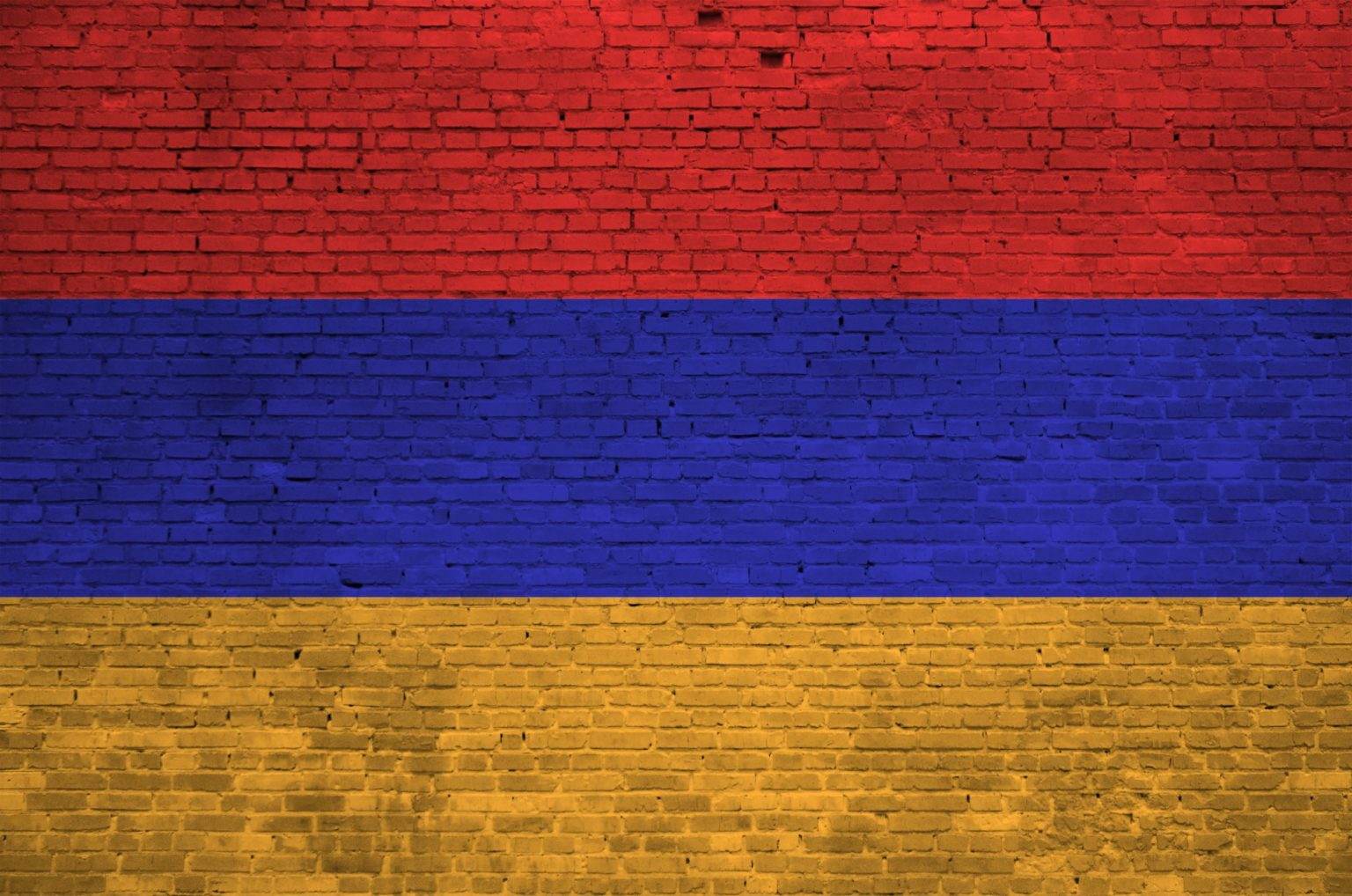 Armenia flag depicted in paint colors on old brick wall close up