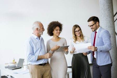 Image of business partners discussing documents and ideas