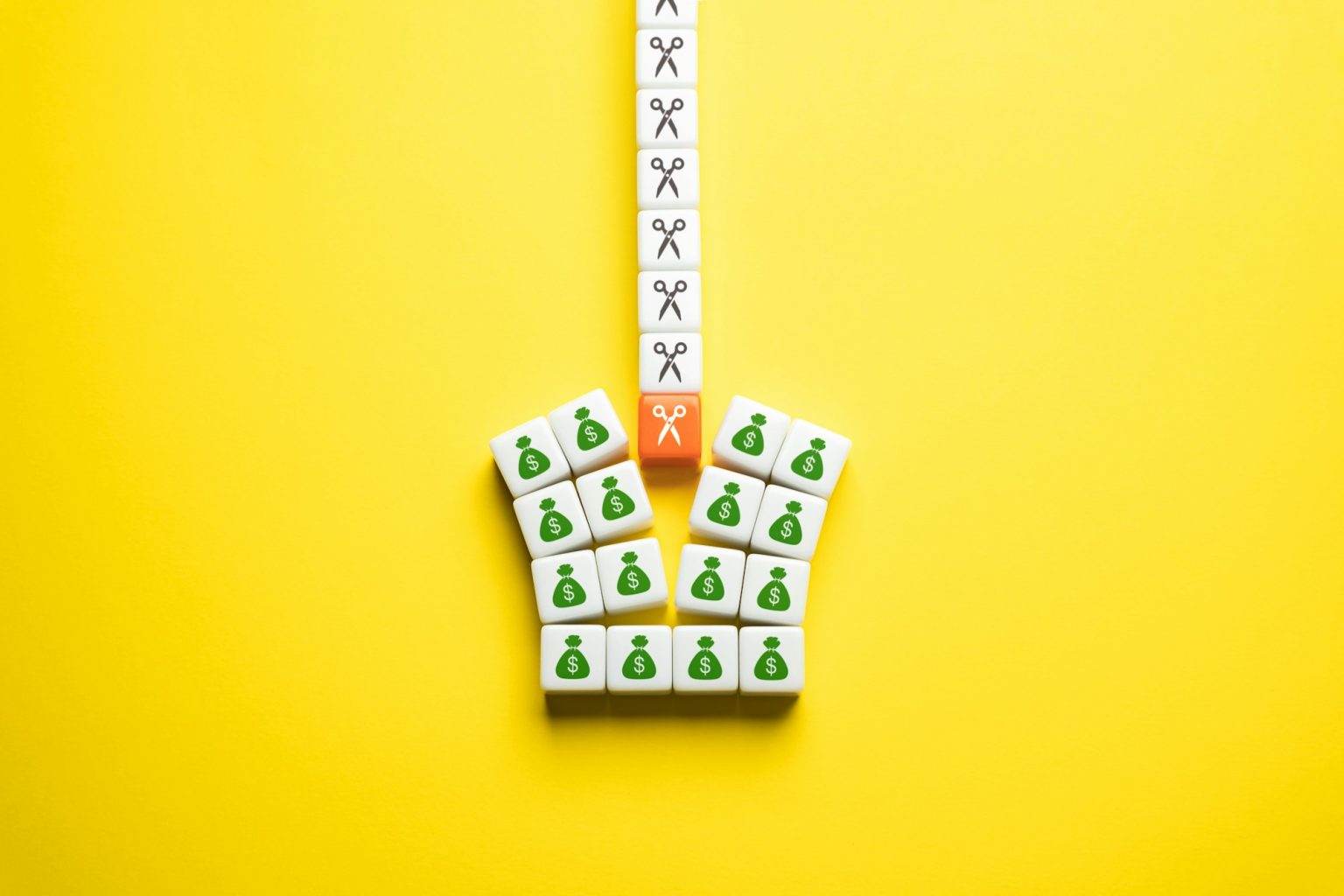 Budget cuts, tough economy. Cutting spendings. Scissors split the budget in half.