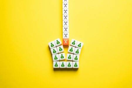 Budget cuts, tough economy. Cutting spendings. Scissors split the budget in half.