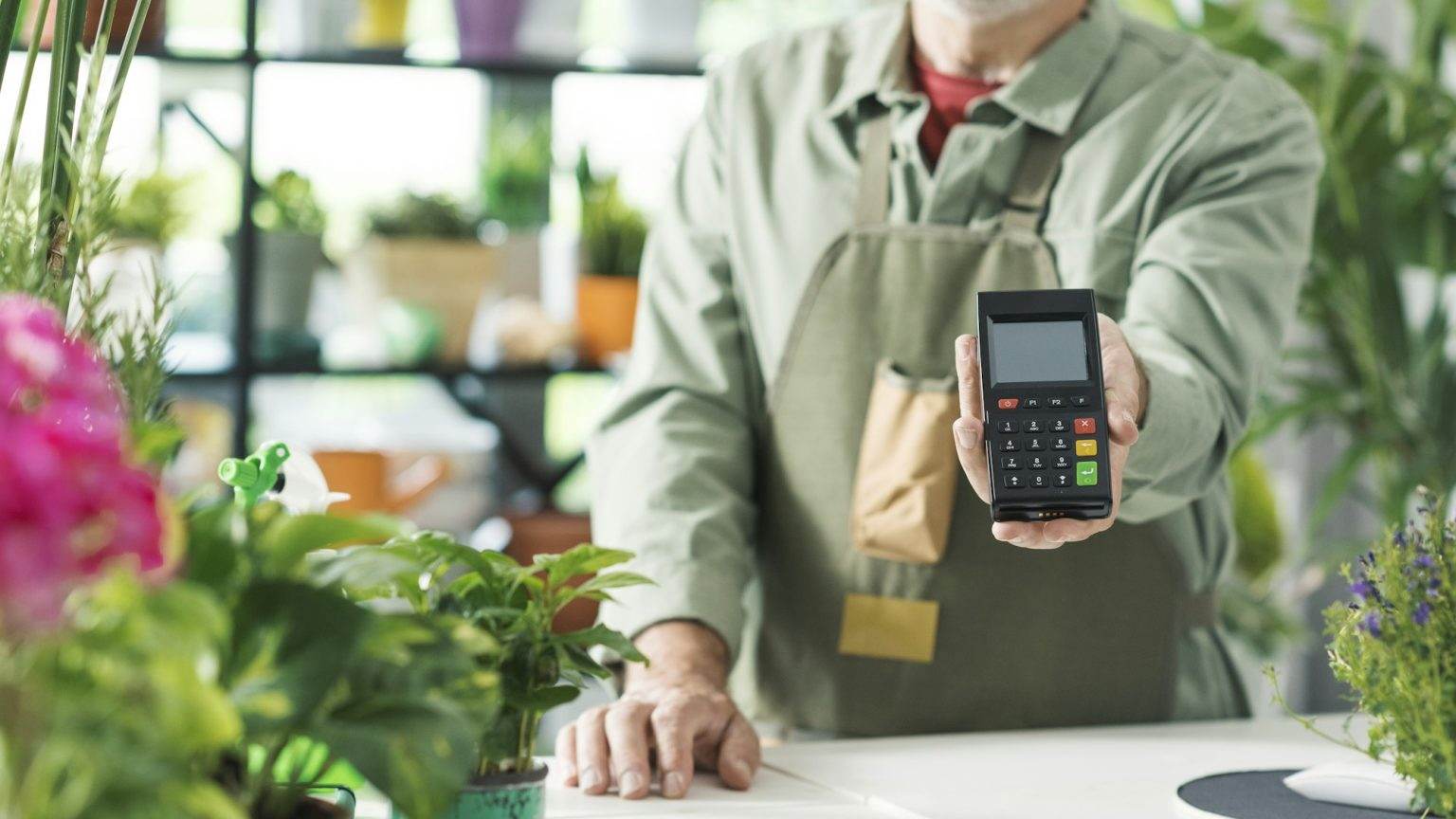 Business owner showing a POS payment terminal