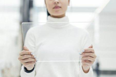 Scientist using a transparent digital screen at a research center