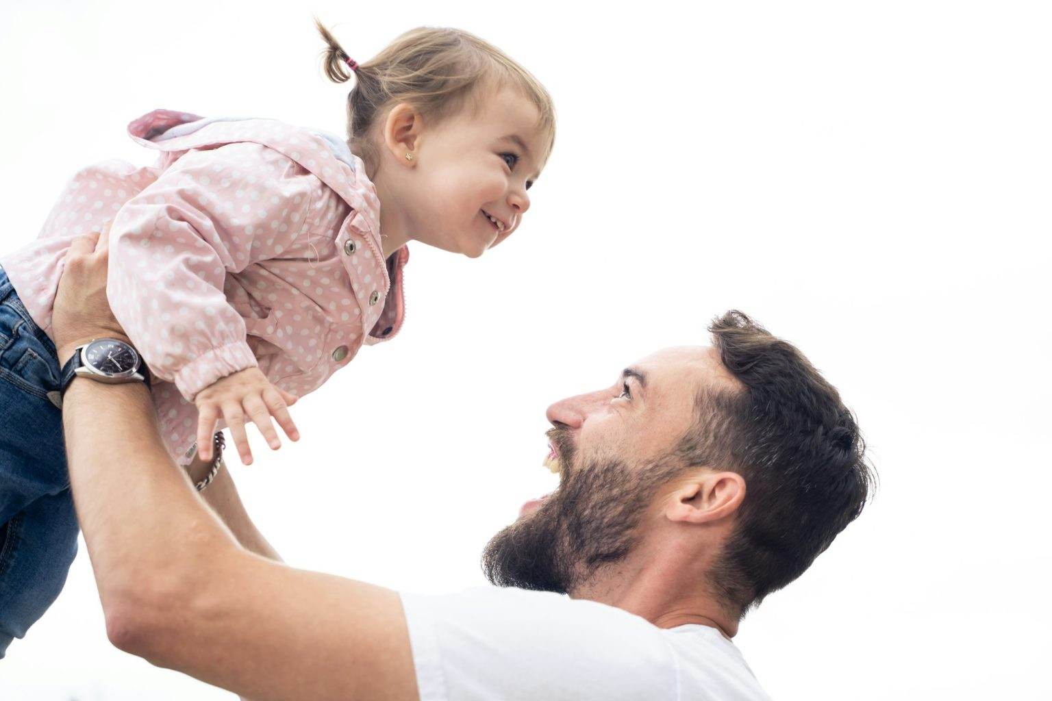 Young dad and little daughter playing outdoors