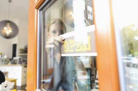 Shopkeeper opening shop for business