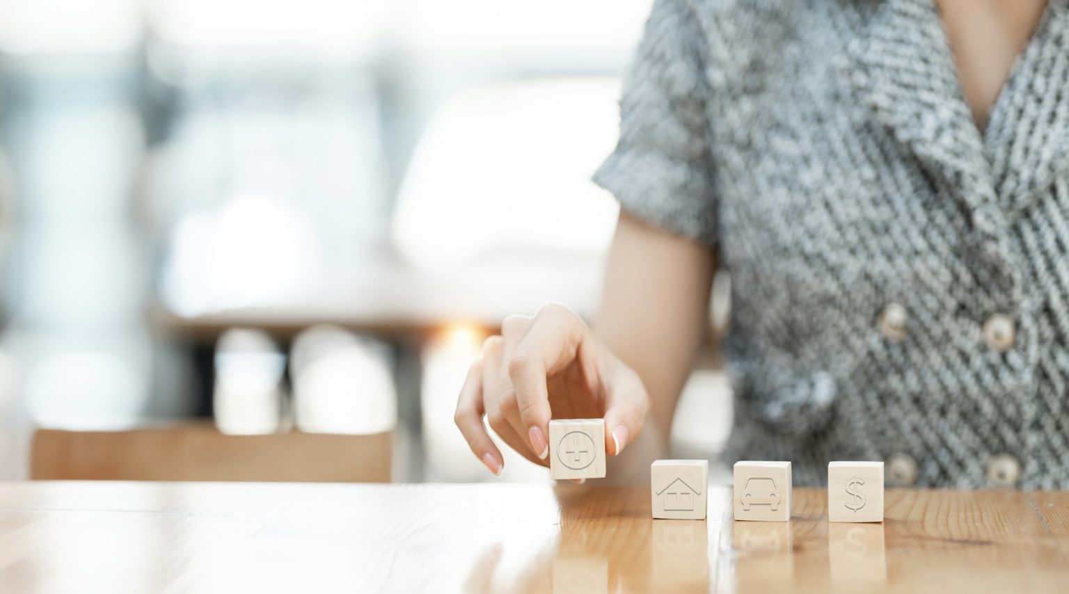 Health insurance conceptual. Hand holding wooden cube with healthcare medical icon.