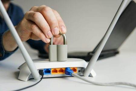 High speed wi-fi router with lock. Man using laptop on the background.