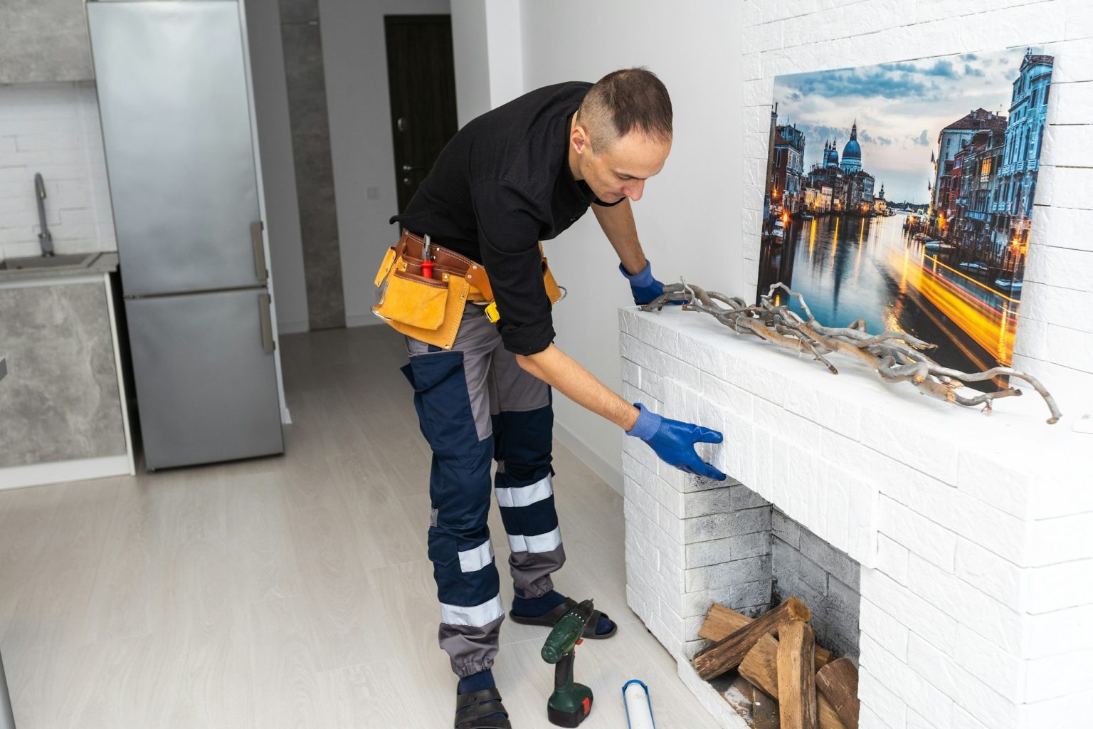 Service technician repairing a fireplace in a home
