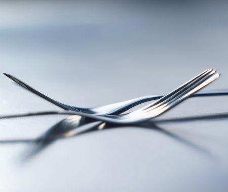 Two forks side by side symbolizing togetherness, dependency and unity. A symbol of teamwork, relati