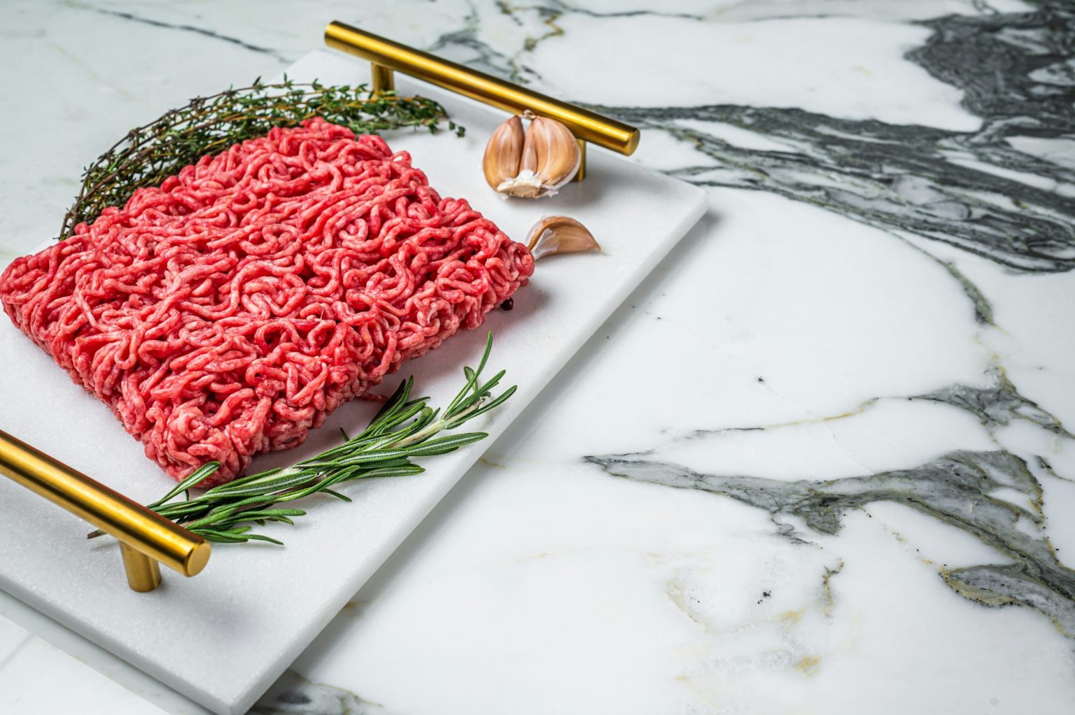 Uncooked Mince from marbled beef Meat, raw ground meat. Marble background. Top view. Space for text