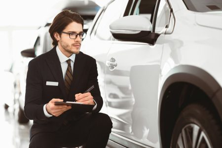 Auto Insurance Agent Sitting Taking Notes Working