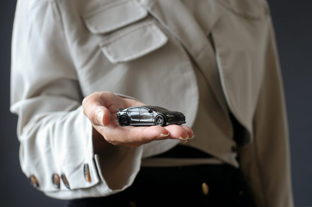 Car on palms, insurance and protection concept