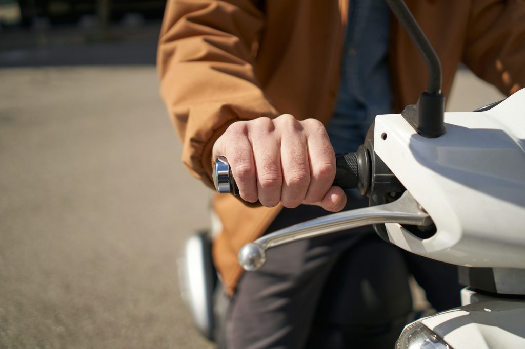 Close-up of the motorcyclist's hand. The concept of speed, movement, forward motion,