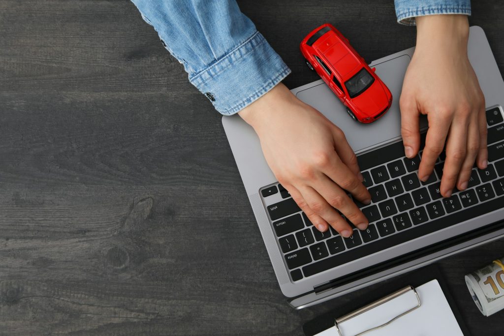 Concept of car purchase and insurance with toy car