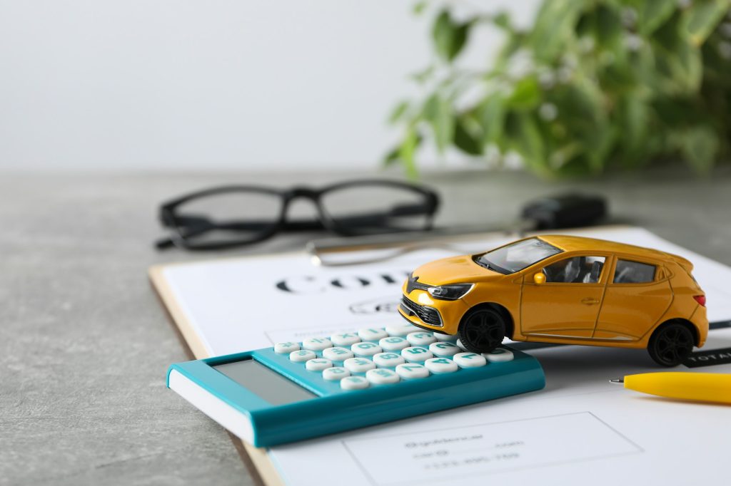 Concept of car purchase and insurance with toy car
