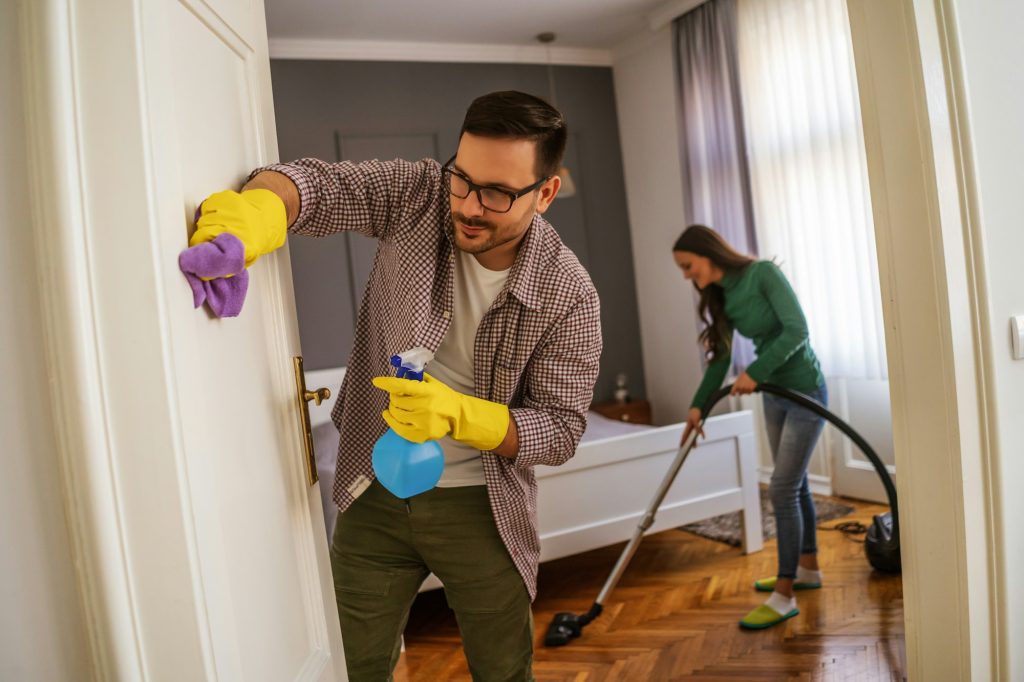 Couple cleaning their home