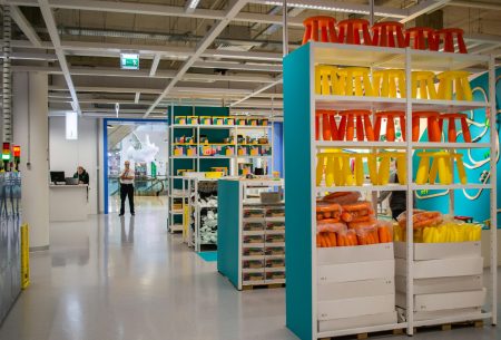 Entrance to IKEA from inside the store. Shelves with bright goods for children