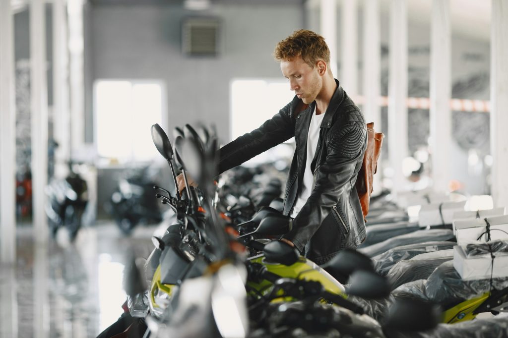 Handsome man choosing a motorcycle to buy