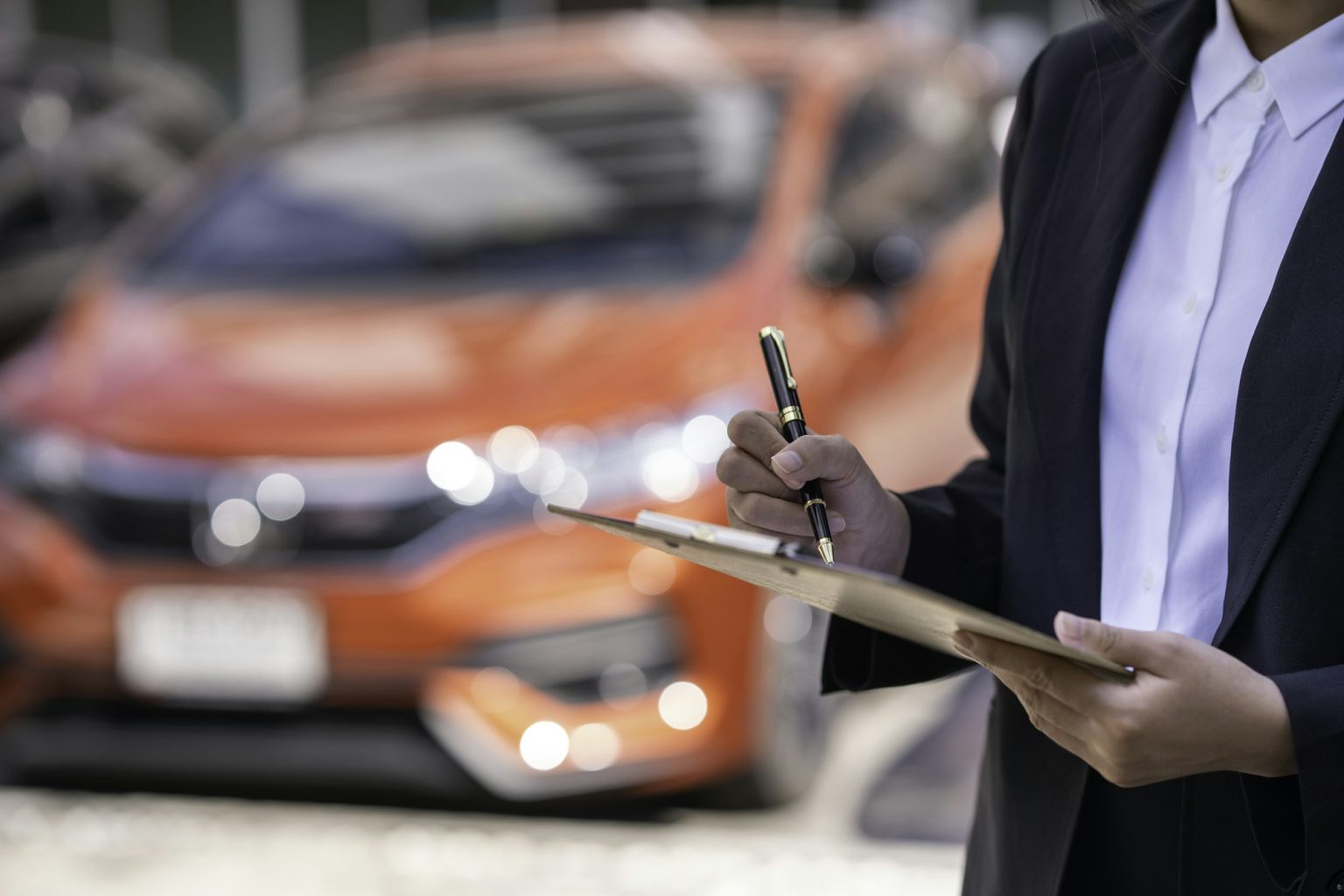 Insurance officer checking the car after the tenant have signed an auto insurance document or a leas