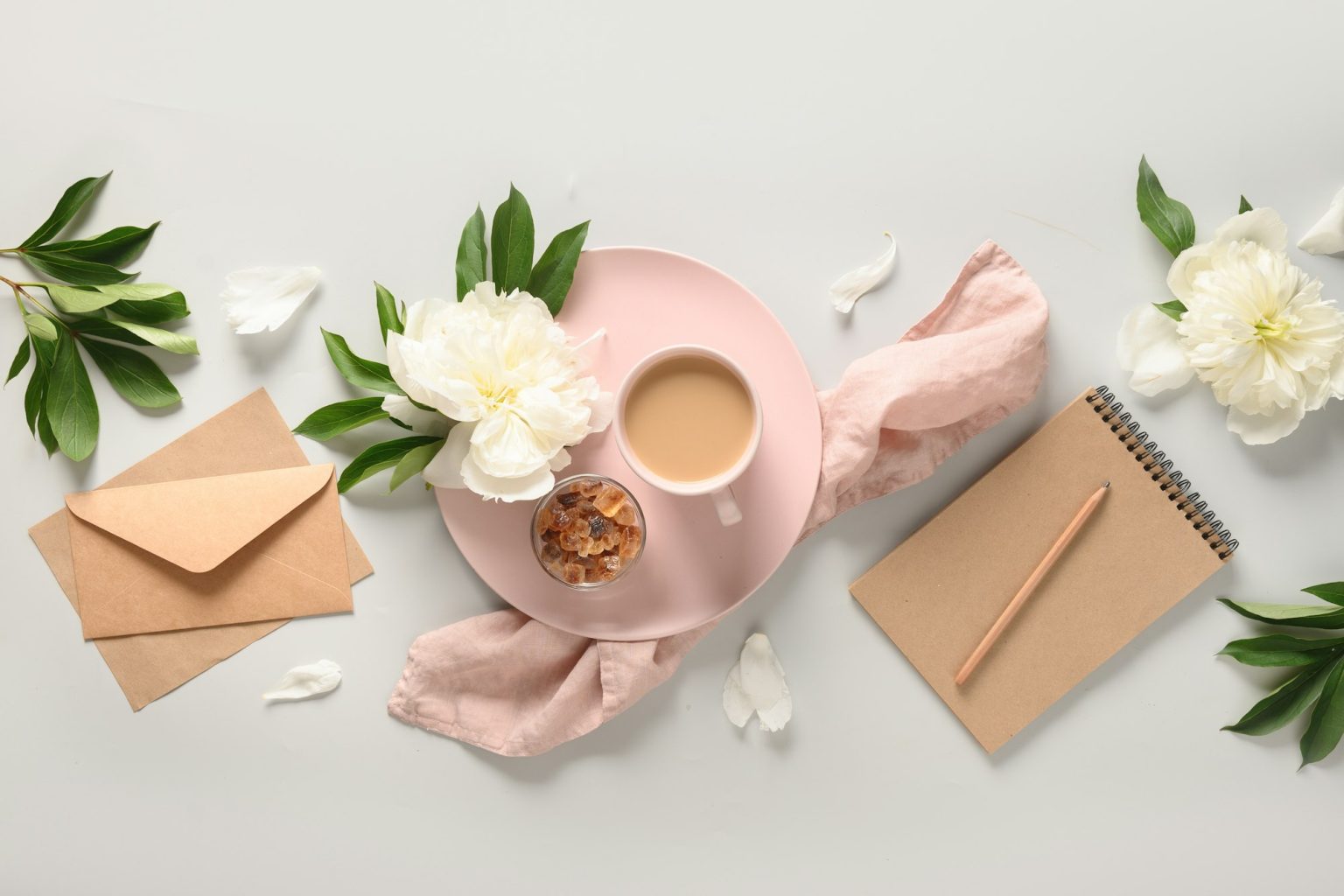 Planning with morning coffee cup, white peonies.