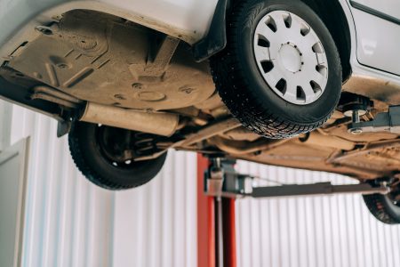 Car lifted on car lift for routine maintenance