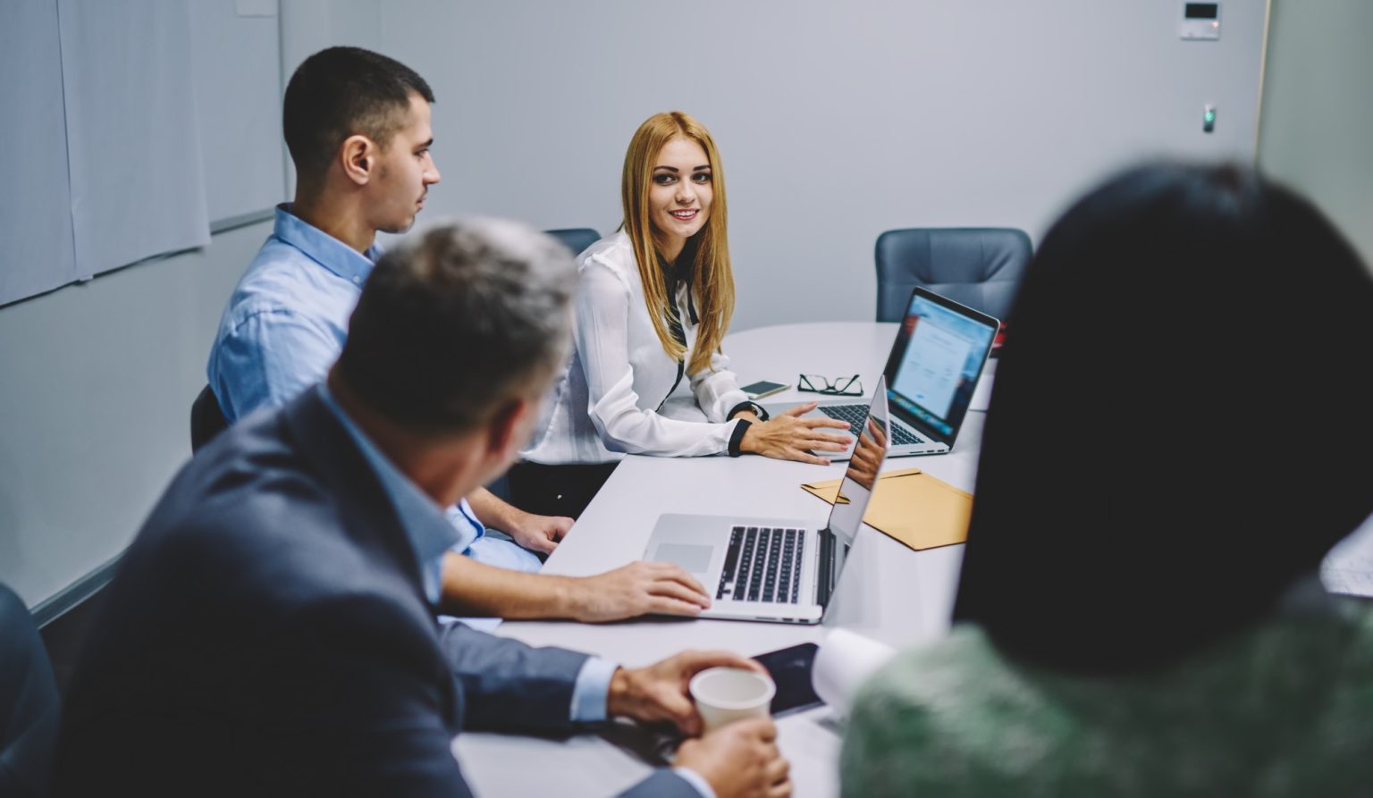 Confident male and female colleagues teambuilding during working process in enterprise