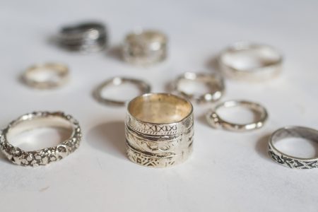 Silver jewelry on a soft white background. Handcraft elegant silver rings.