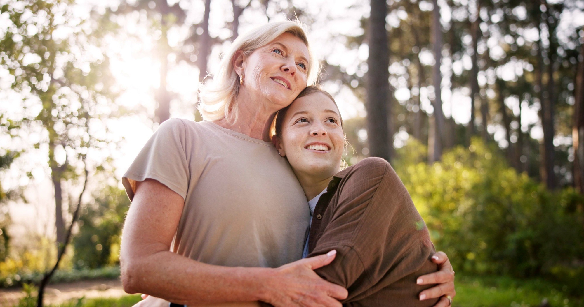 Woman, mother and thinking in nature with hug, love and care for healthy relationship. Mature mom,