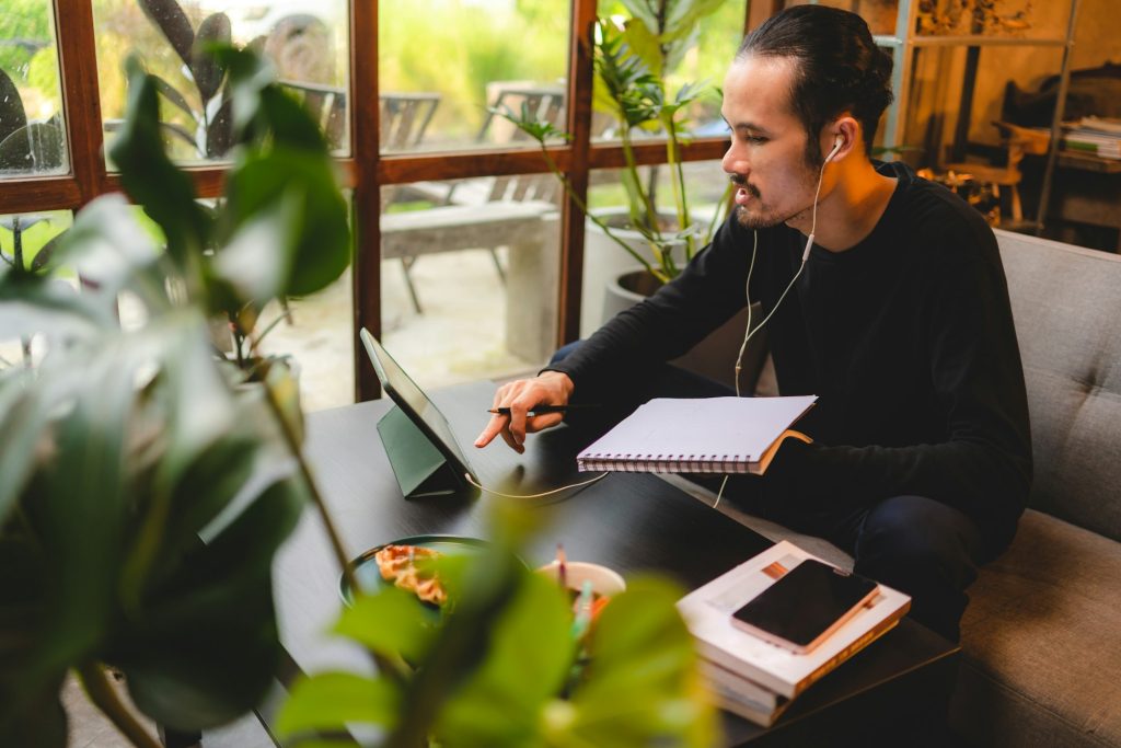 young man person using computer laptop or tablet for work and learning online