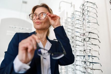 Businesswoman buys glasses in an optical store
