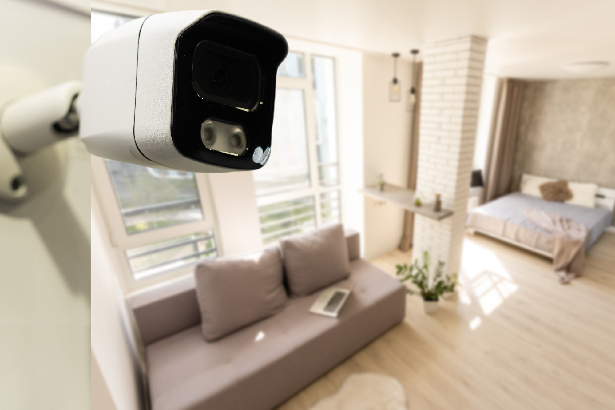 Close Up Object Shot of a Modern Wi-Fi Surveillance Camera on a White Wall in a Cozy Apartment Has