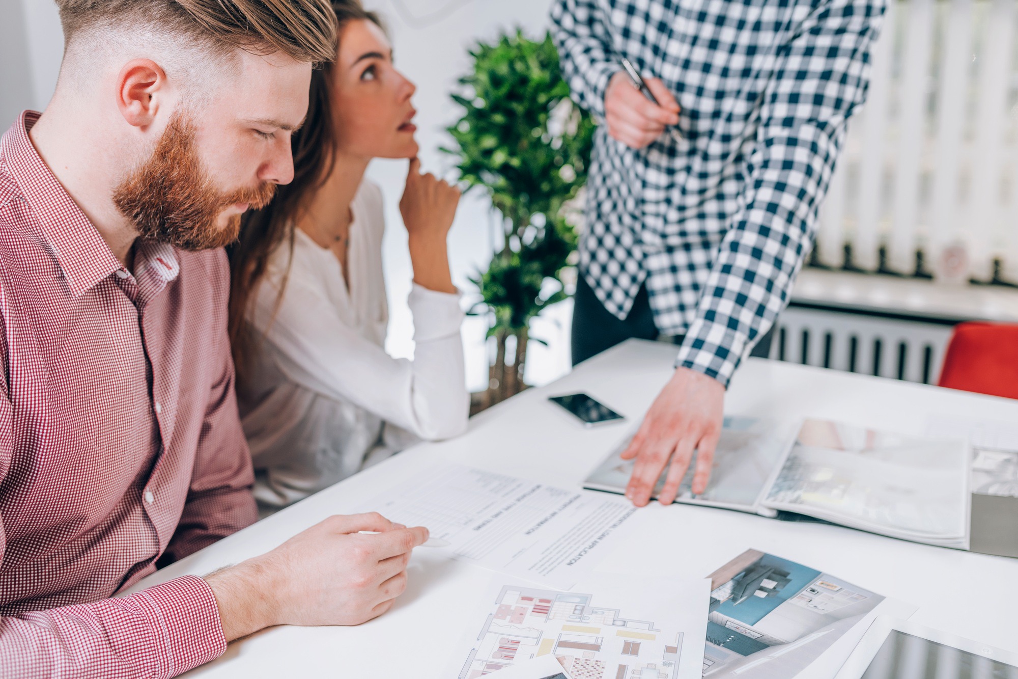 Couple in Real-Estate Agency Talking to Real Estate Agent