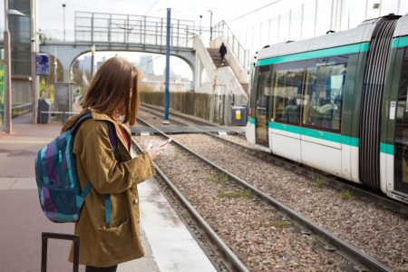 girl tourist waits for the train