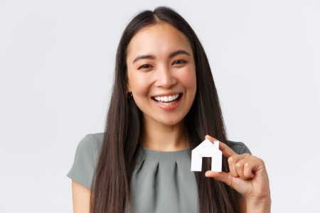 Insurance, loan, real estate and family concept. Close-up of smiling beautiful asian woman buying