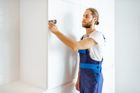 Man measuring distances at home