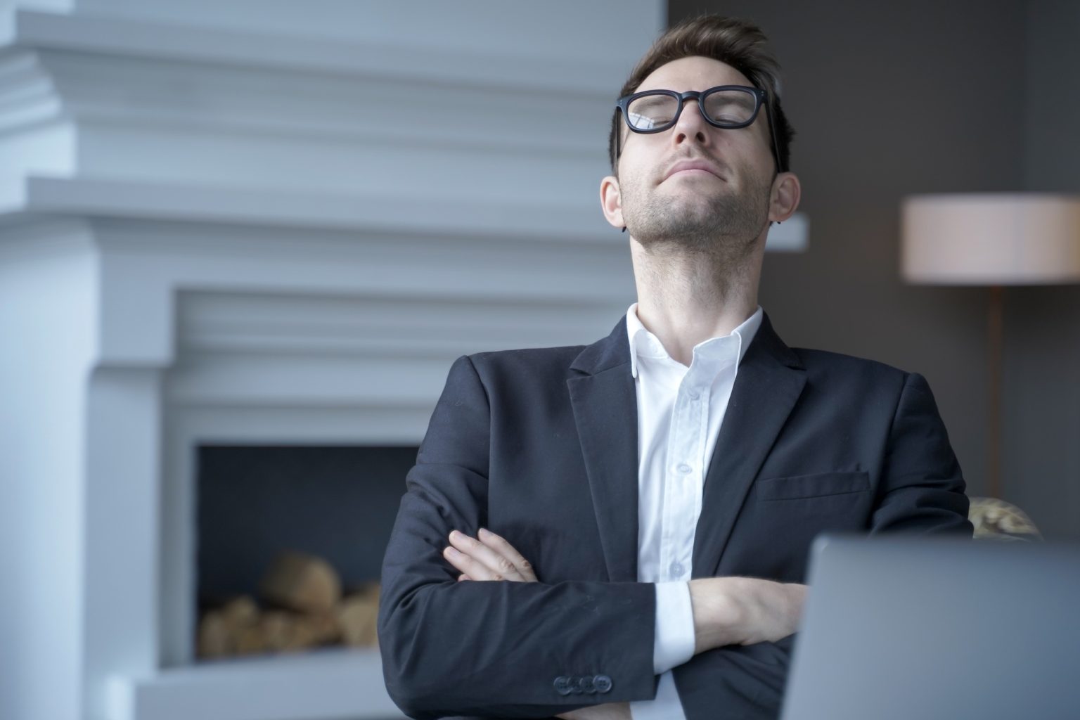 Mediative german businessman sit at desk with eyes closed taking rest from computer work