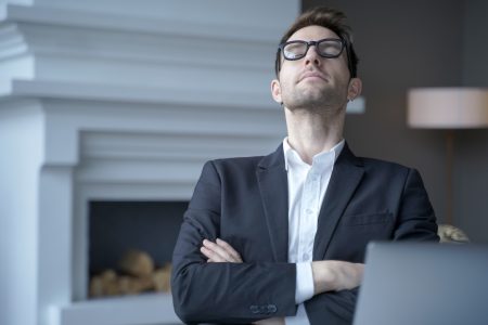 Mediative german businessman sit at desk with eyes closed taking rest from computer work