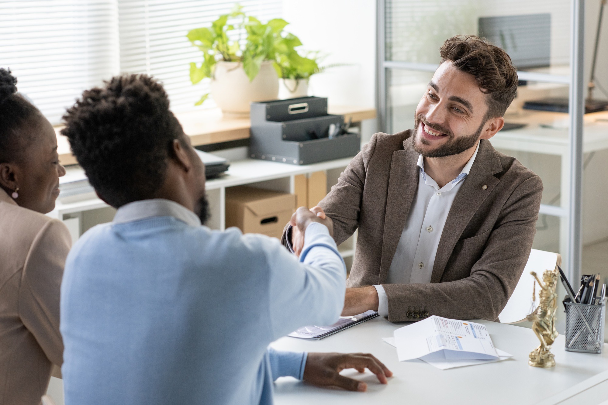 Smiling Banking Specialist Meeting With Couple