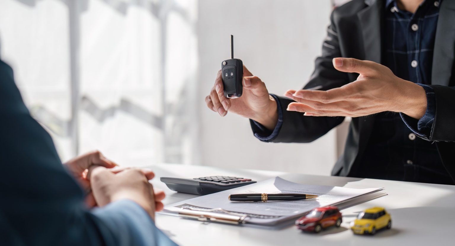 Transportation sell automotive business concept. Close up hands of sell auto agent giving car