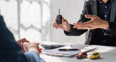 Transportation sell automotive business concept. Close up hands of sell auto agent giving car