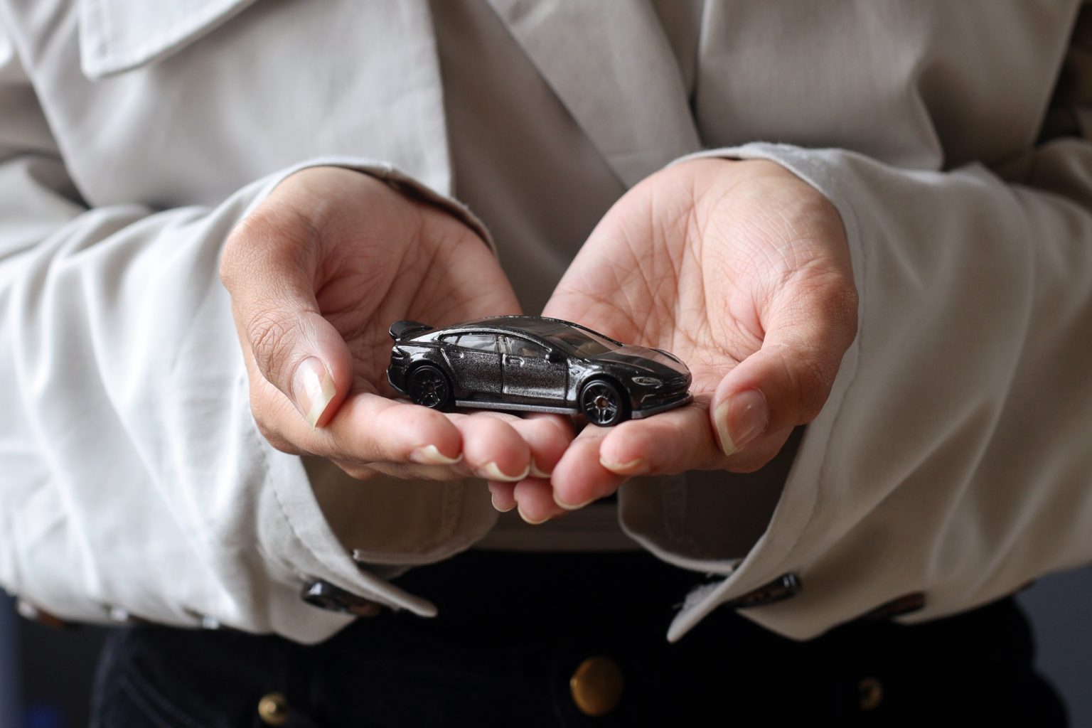 Car toy on palms, car insurance concept