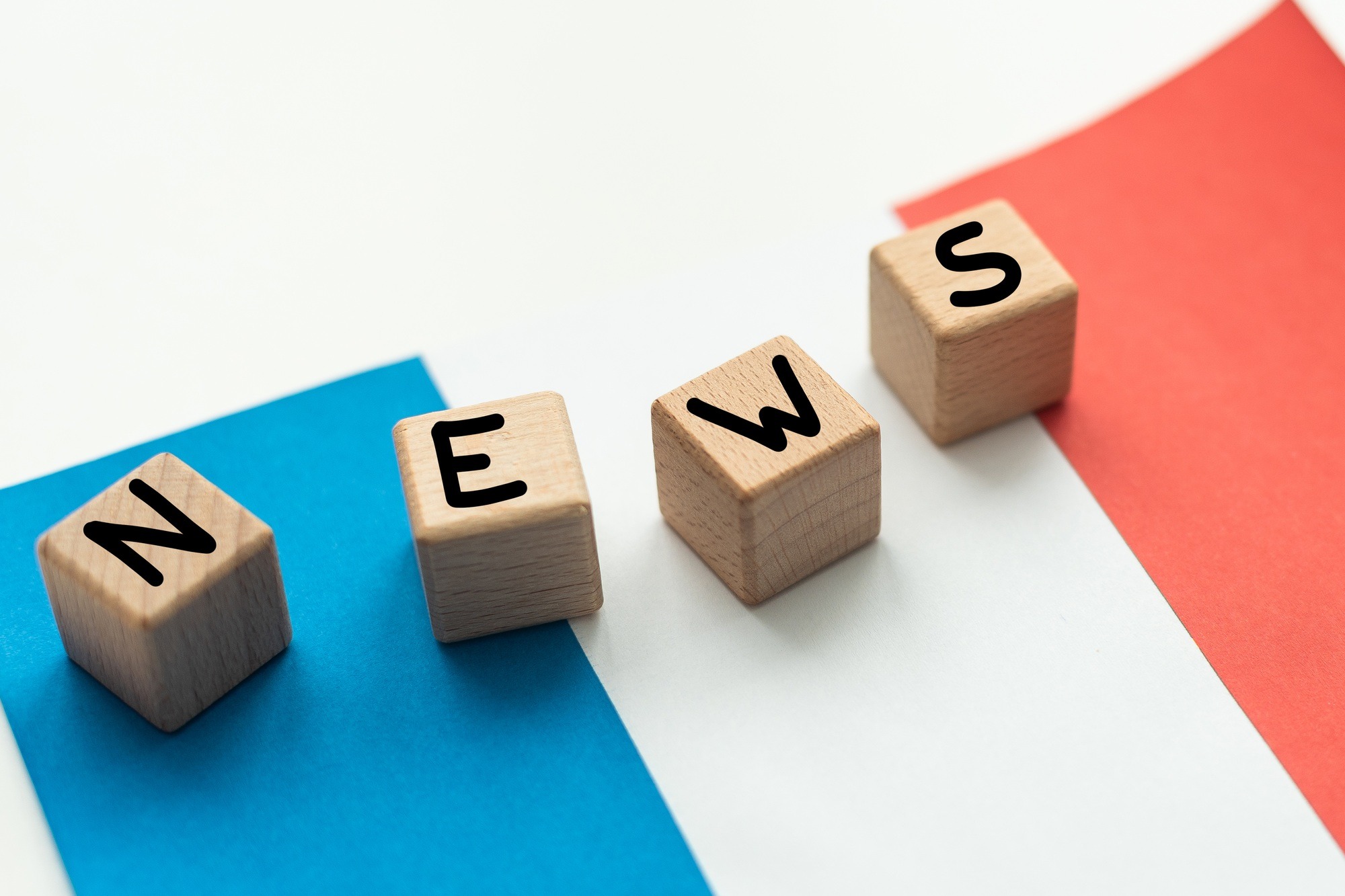 concept news feeds - Breaking news, French country's flag, blackboard and the text Latest News on